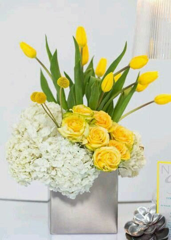modern arrangement of yellow blooms such as tulips 