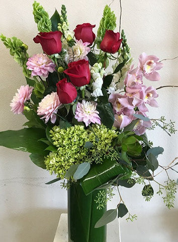 Tall arrangement of Orchids and Roses 