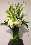 elevated arrangement of white and green blooms with orchids