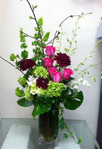 beautiful arrangement of seasonal flowers such as roses and hydrangeas 